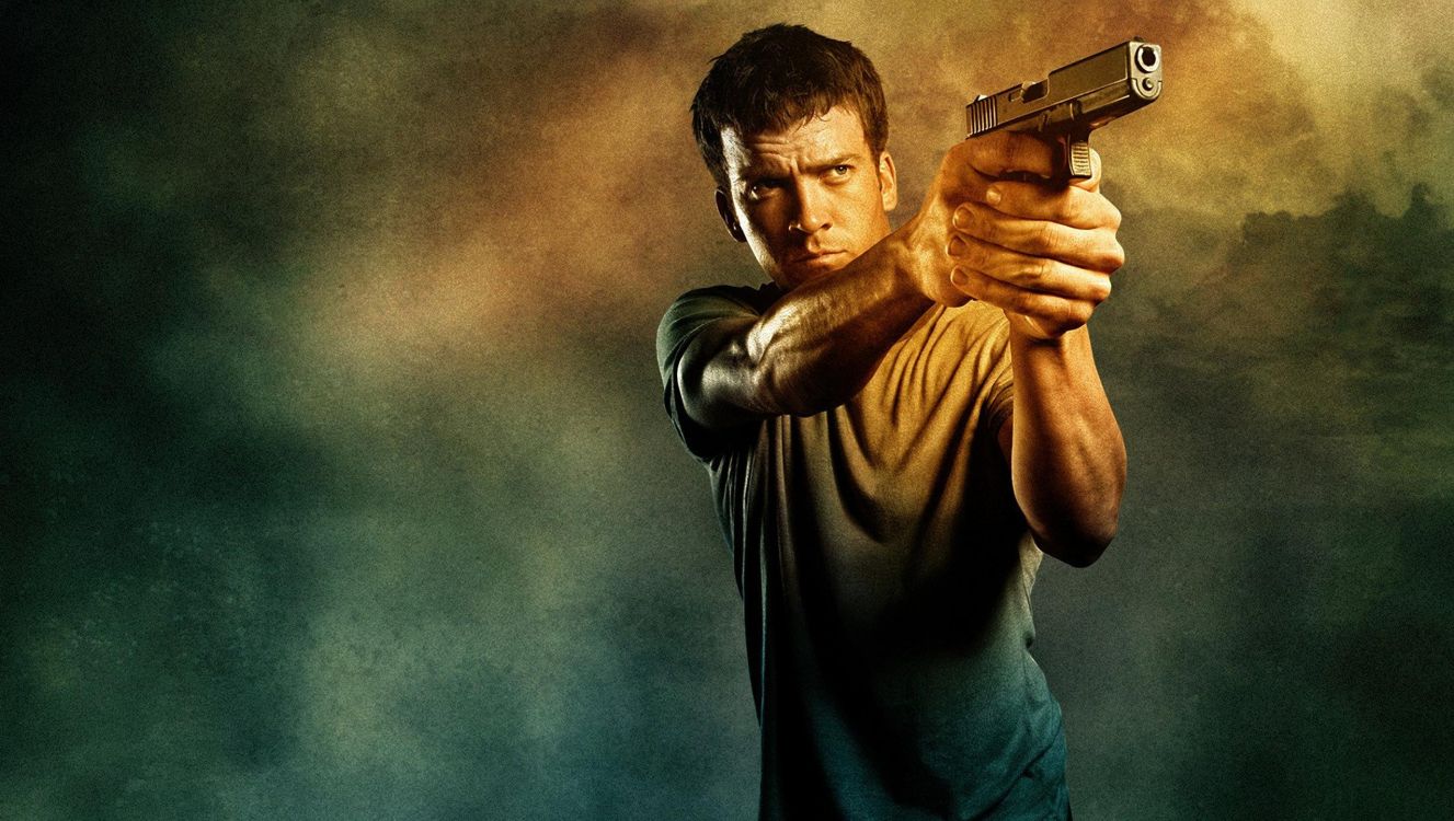 Homme en T-shirt Gris à Col Rond Tenant un Pistolet Semi-automatique Noir. Wallpaper in 2552x1442 Resolution