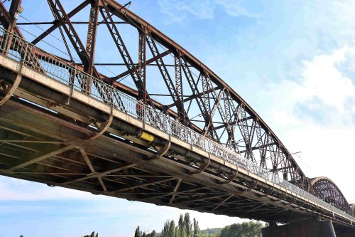 Image brown metal bridge under blue sky during daytime