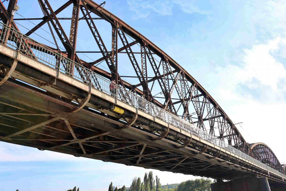 brown metal bridge under blue sky during daytime