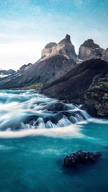 Image rocky mountain beside body of water