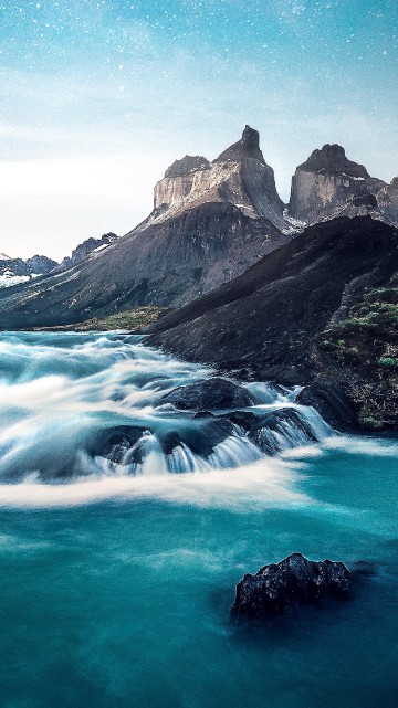 Image rocky mountain beside body of water