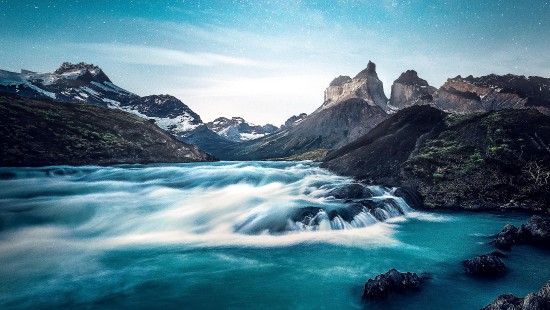 Image rocky mountain beside body of water