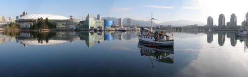 Image white and red boat on water near city buildings during daytime