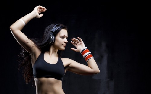 Image woman in black sports bra holding her hair