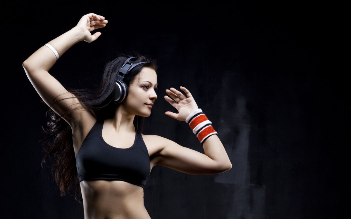 woman in black sports bra holding her hair