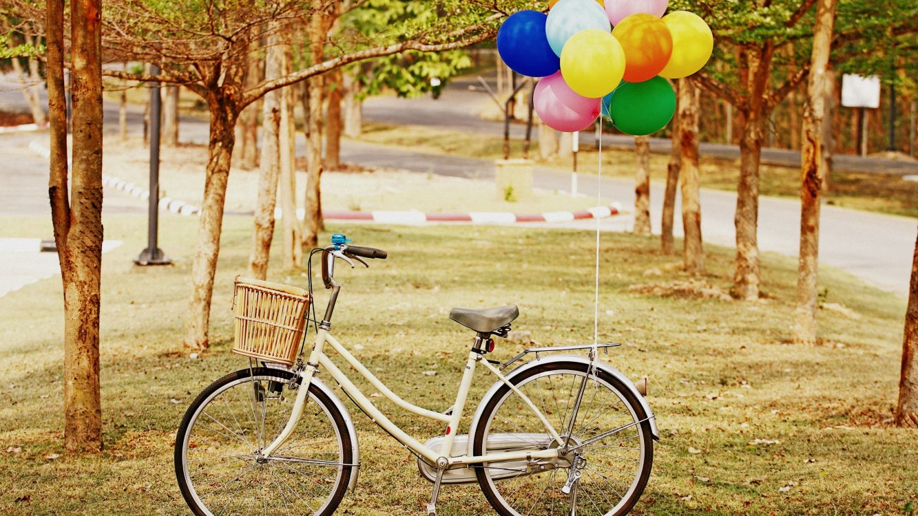 yellow and blue balloons on bicycle