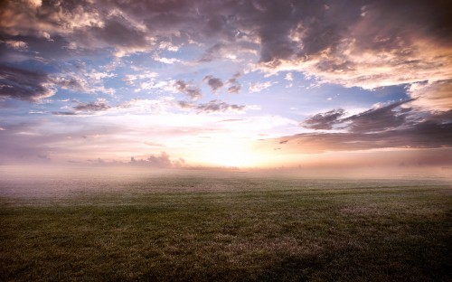 Image green grass field under cloudy sky during daytime