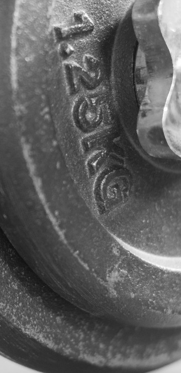 Image black dumbbell on white textile