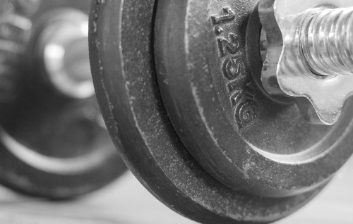 Image black dumbbell on white textile