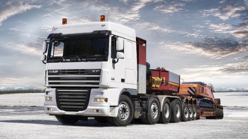 Image white and red freight truck on road during daytime