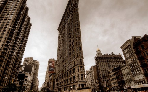 Image brown concrete high rise buildings under white clouds during daytime