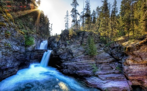 Image waterfalls between green trees during daytime