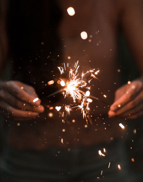 person holding sparkler during night time