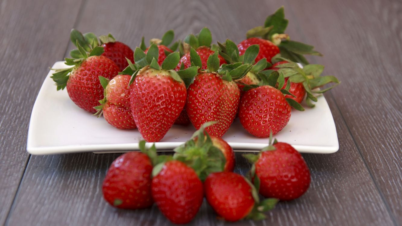 strawberries on white ceramic plate