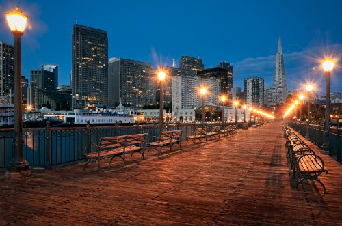 Image brown wooden bench near body of water during night time