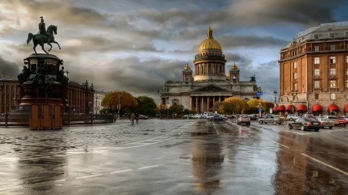 Image brown dome building near green trees under cloudy sky during daytime