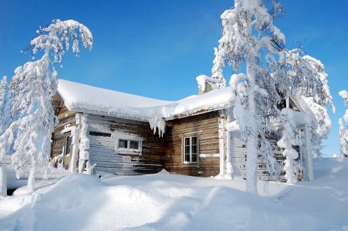 Image brown wooden house covered with snow during daytime