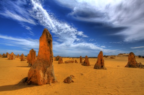 Image brown rock formation under blue sky and white clouds during daytime