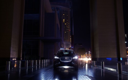 Image black car parked near building during night time