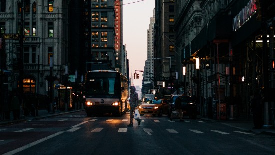 Image cars on road between high rise buildings during daytime
