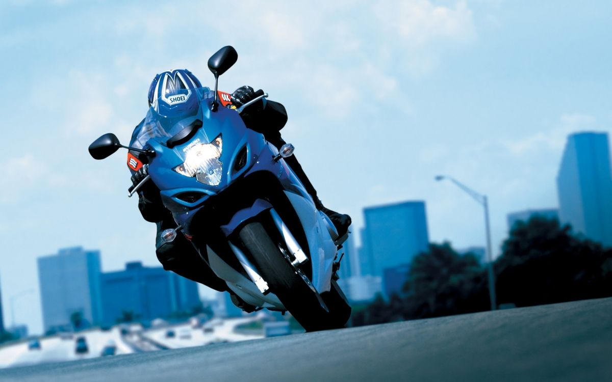 man in white and black motorcycle helmet riding white and black sports bike