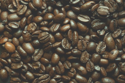 Image brown coffee beans on black surface