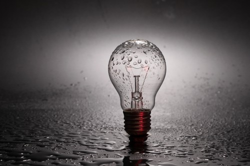 Image water drop on clear glass light bulb