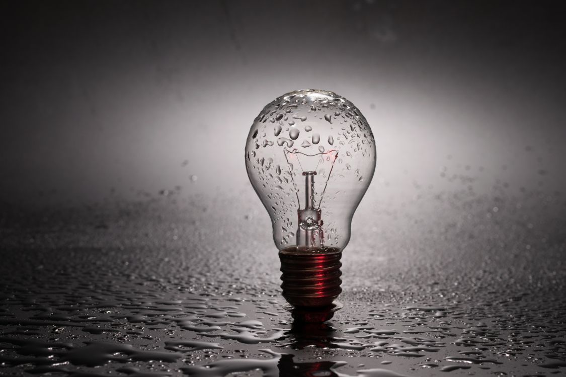 water drop on clear glass light bulb