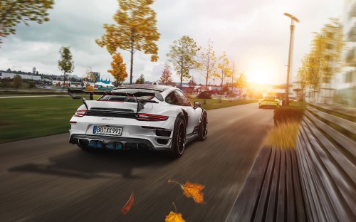 Image white and black porsche 911 on road during daytime