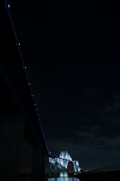 white and black bridge under dark sky