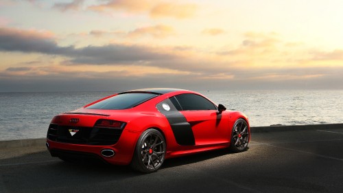 Image red ferrari 458 italia on beach shore during daytime