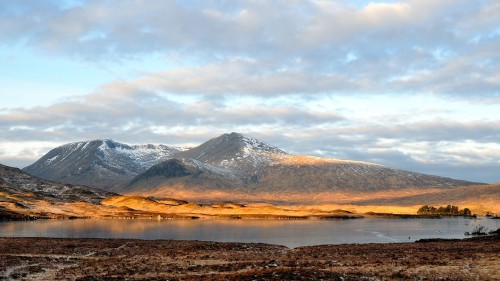 Image brown and white mountains under white clouds during daytime