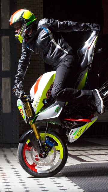 Image man in black leather jacket riding green motorcycle