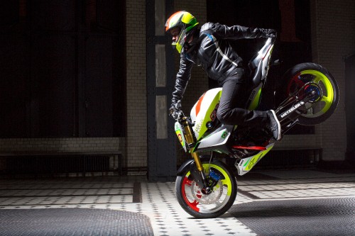 Image man in black leather jacket riding green motorcycle