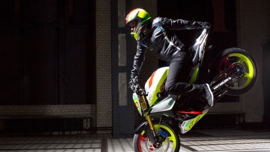 Image man in black leather jacket riding green motorcycle