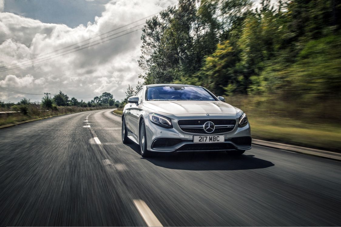 blue mercedes benz coupe on road during daytime