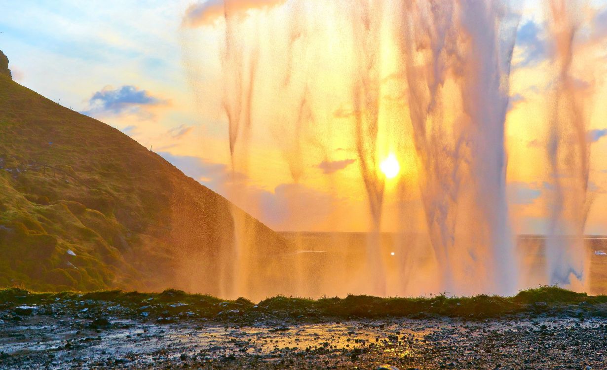 water falls on mountain during daytime