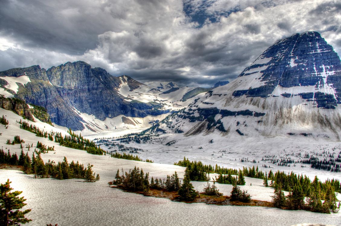 snow covered mountain under cloudy sky during daytime