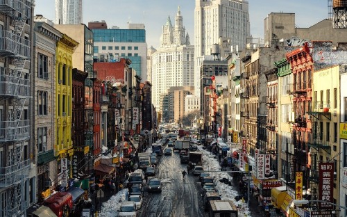 Image cars parked on street near high rise buildings during daytime