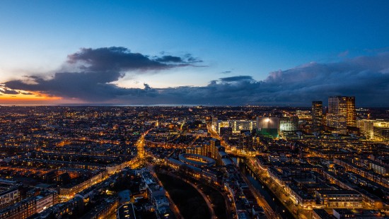 Image city with high rise buildings during night time