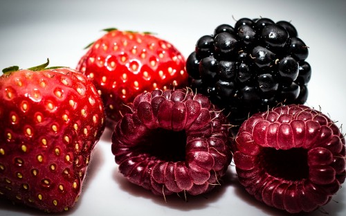 Image red strawberries on white surface