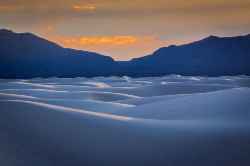 Image snow covered field near mountains during daytime