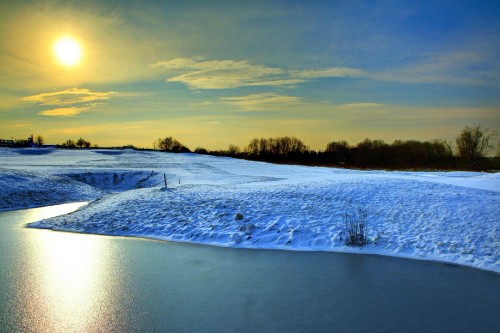 Image snow covered field under cloudy sky during daytime