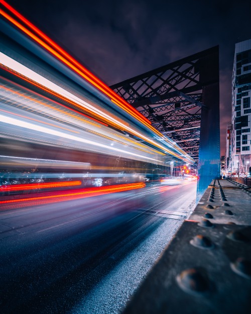 Image time lapse photography of cars on bridge during night time