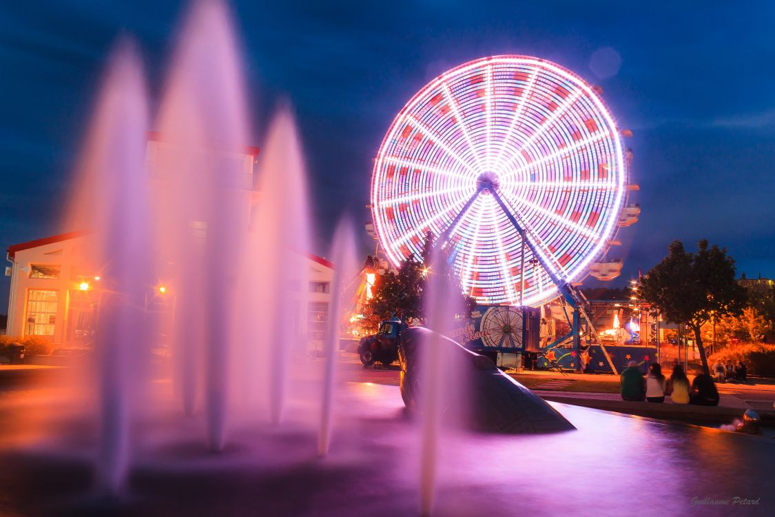 white round building with lights during night time