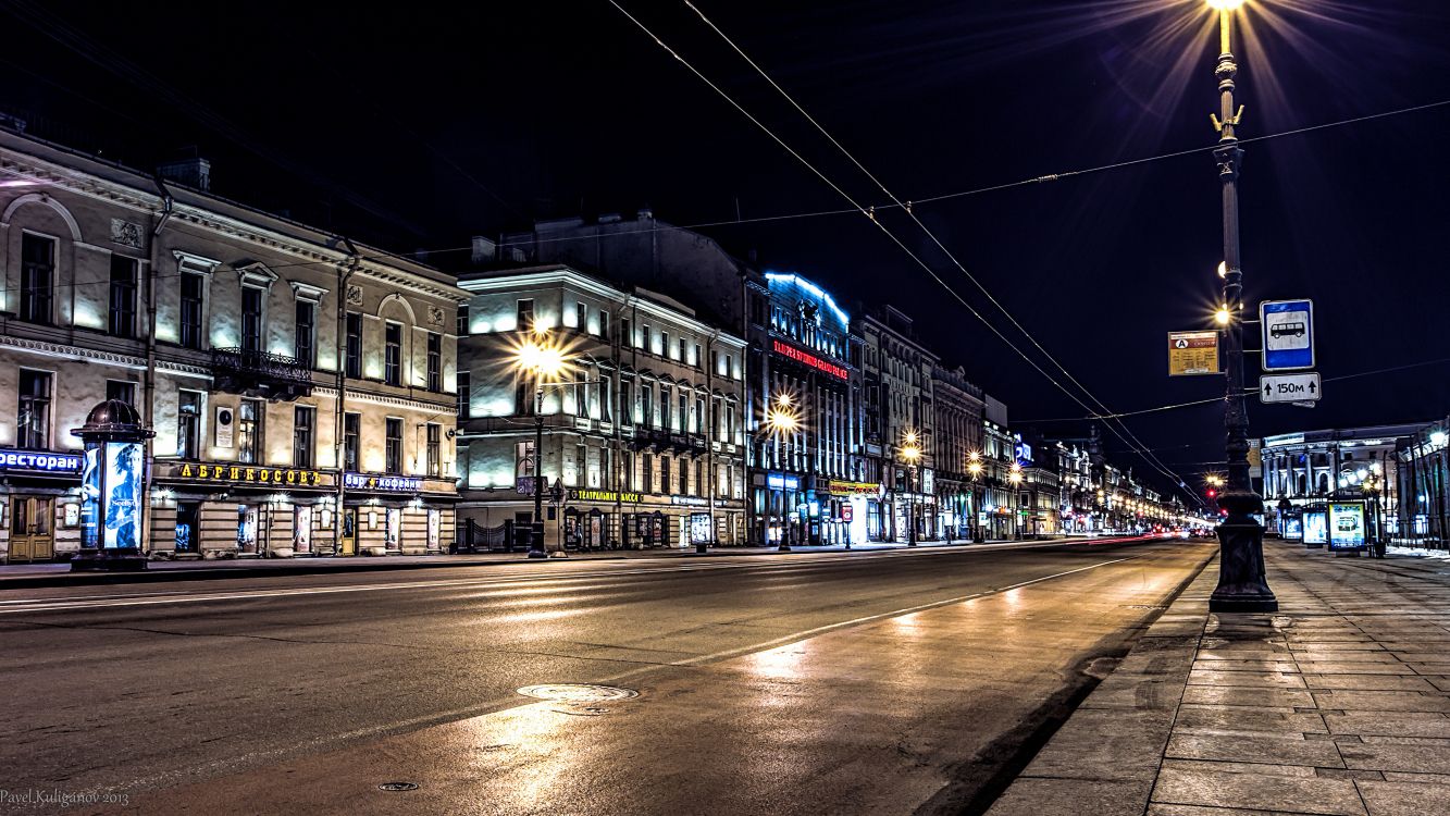 city buildings with lights turned on during night time