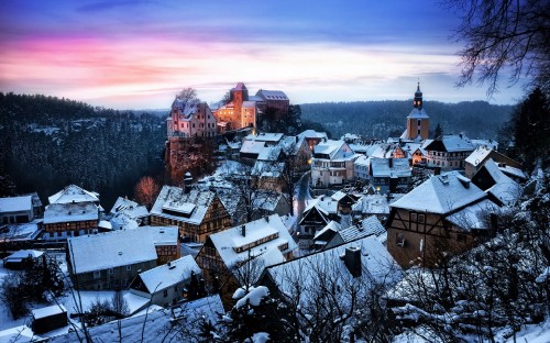 Image white and brown houses near mountain under cloudy sky during daytime