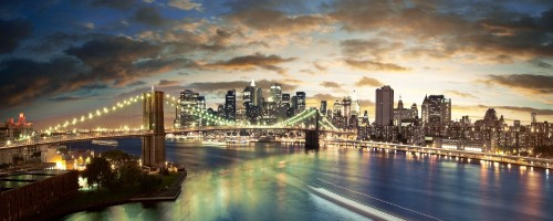 Image city skyline across body of water during night time