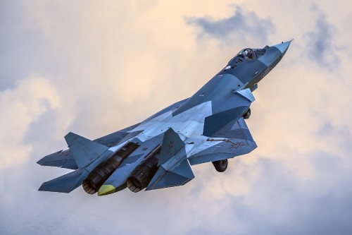 Image blue jet plane in mid air during daytime