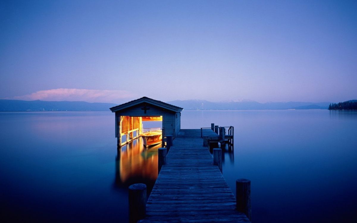 brown wooden house on dock during daytime